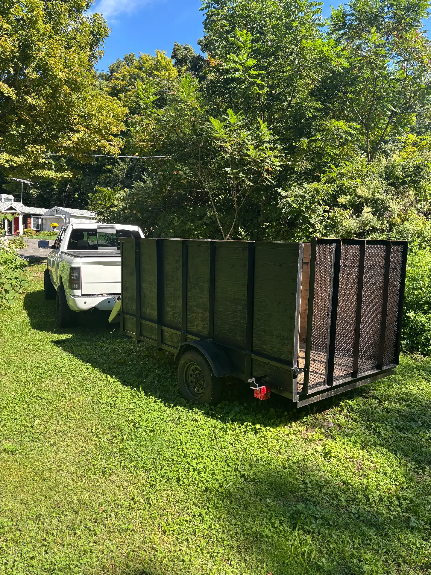 Load and Go high-side junk removal trailer side view in Oxford Connecticut