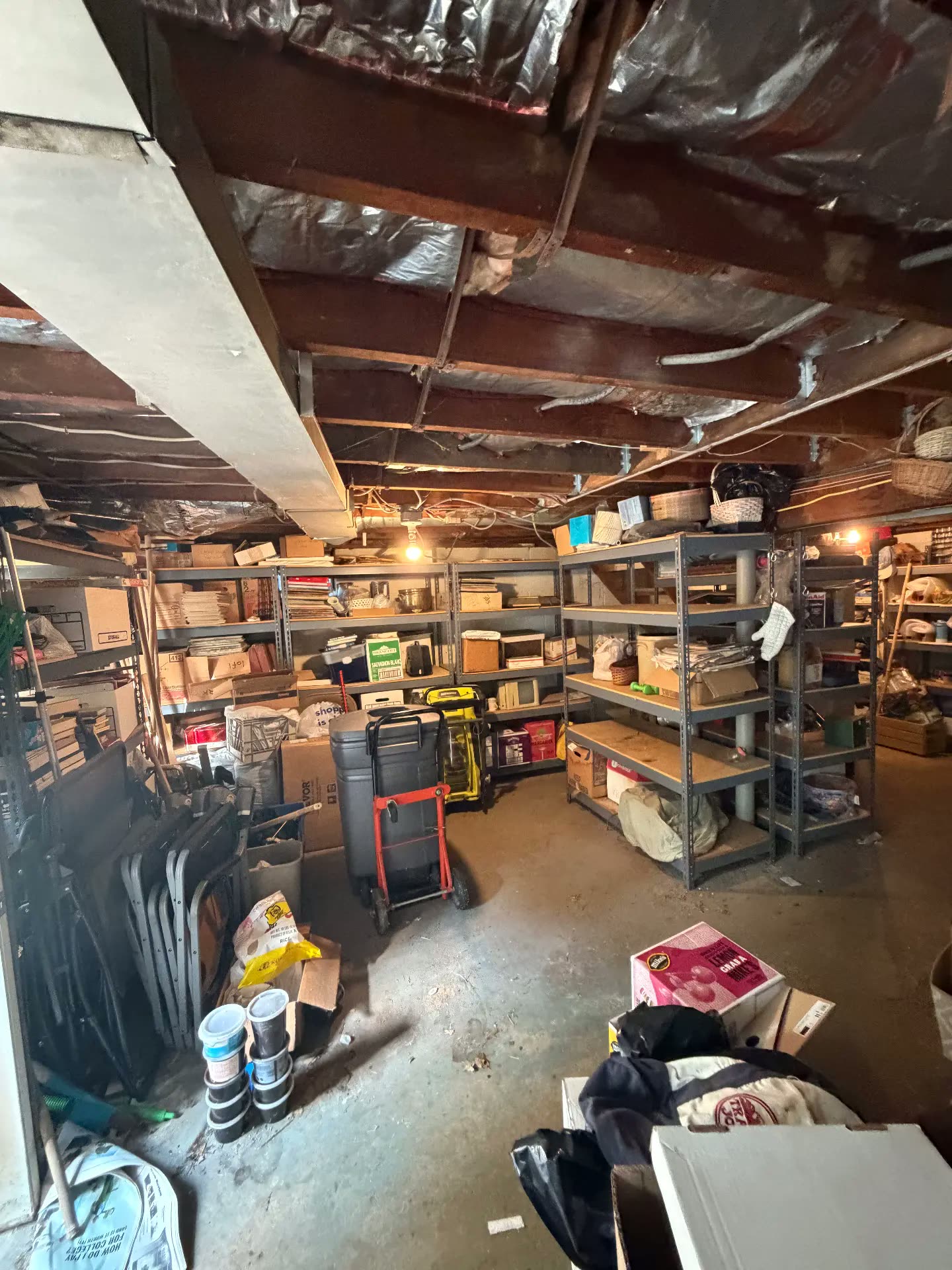 Basement storage shelves packed before junk removal