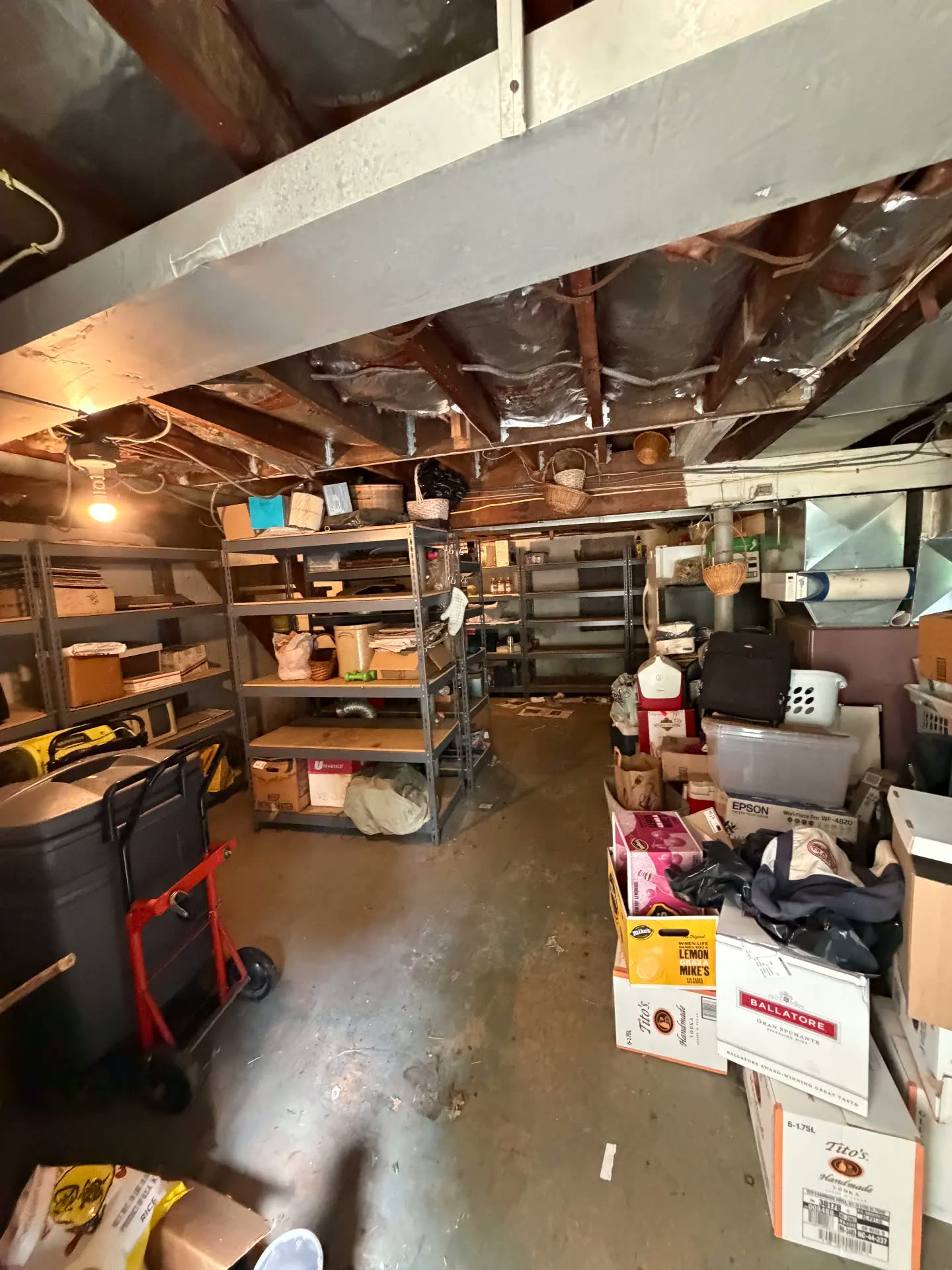 Basement shelf area filled with items before removal