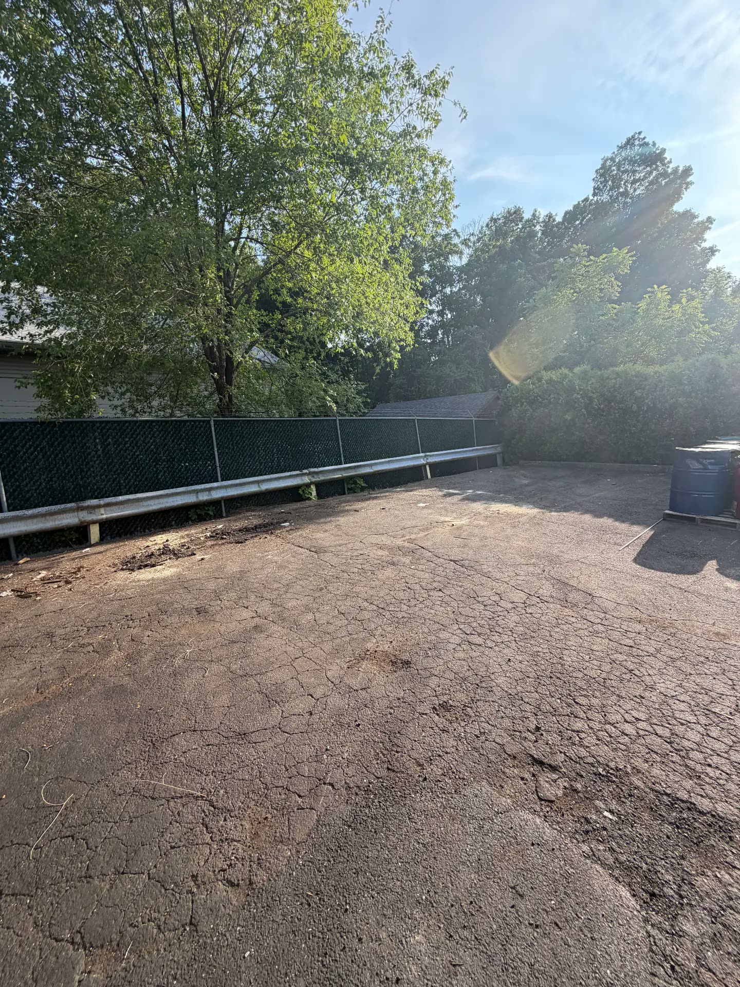 Cleared asphalt lot after construction debris removal