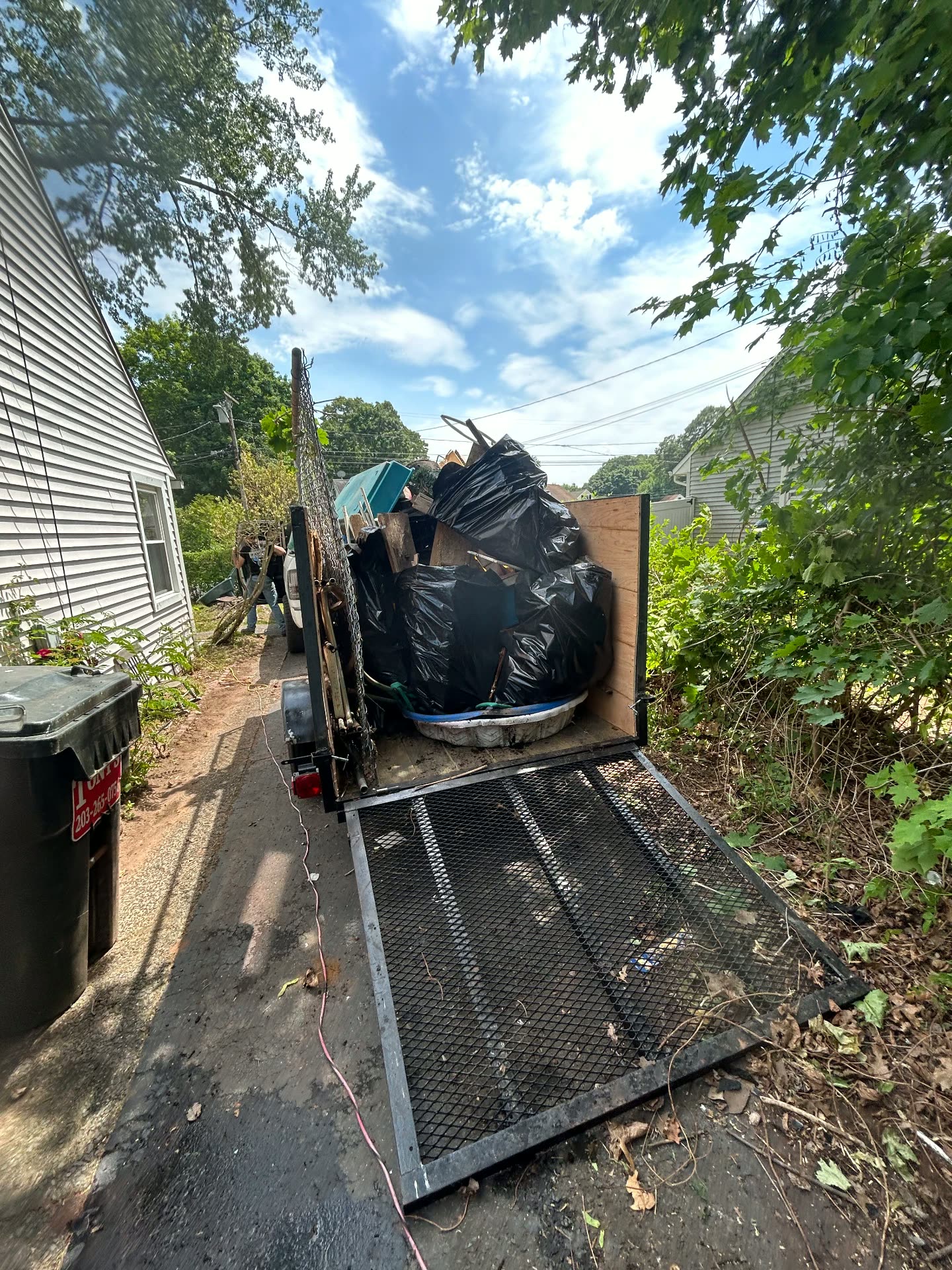 Trailer loaded with bags and yard junk