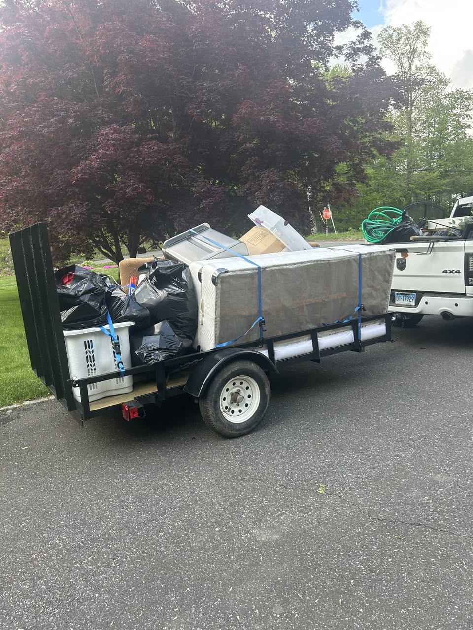 Loaded trailer strapped down and ready to haul after cleanout