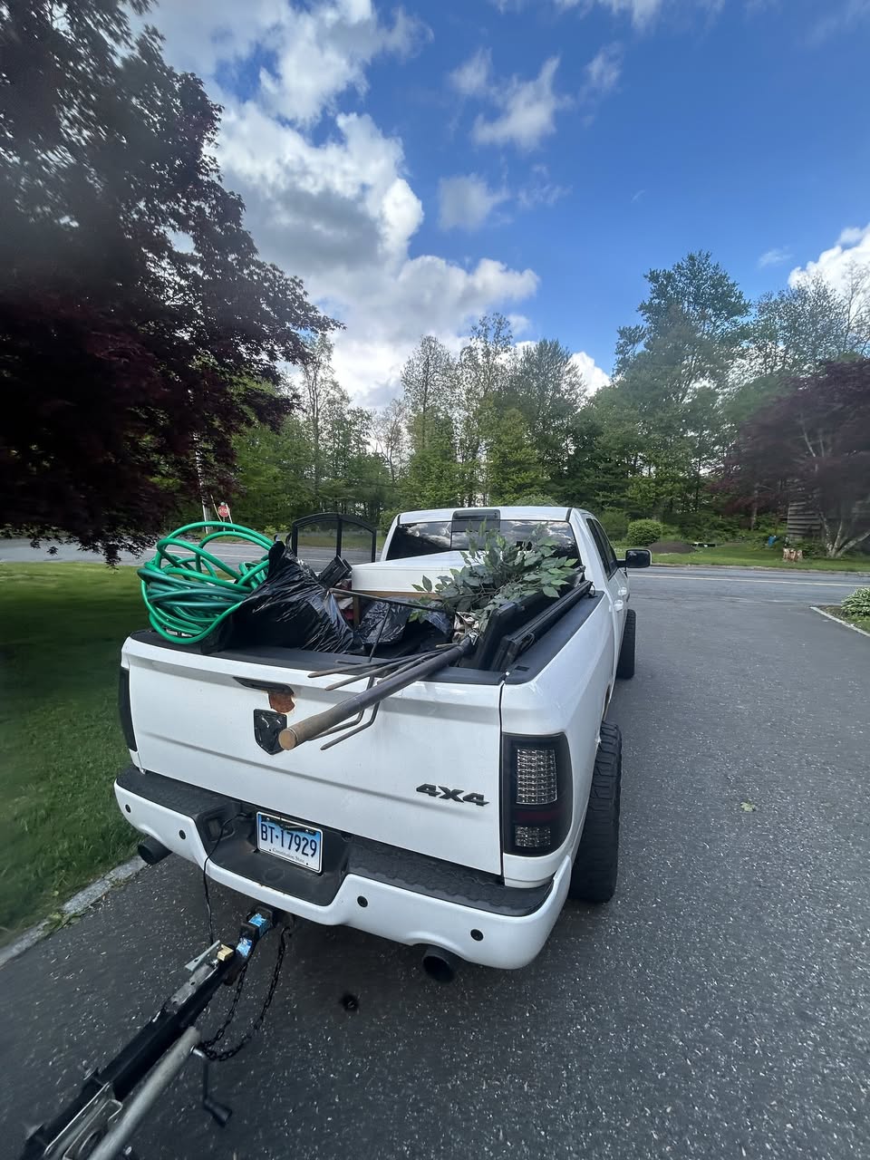 Truck bed loaded with yard debris and bags after yard cleanout