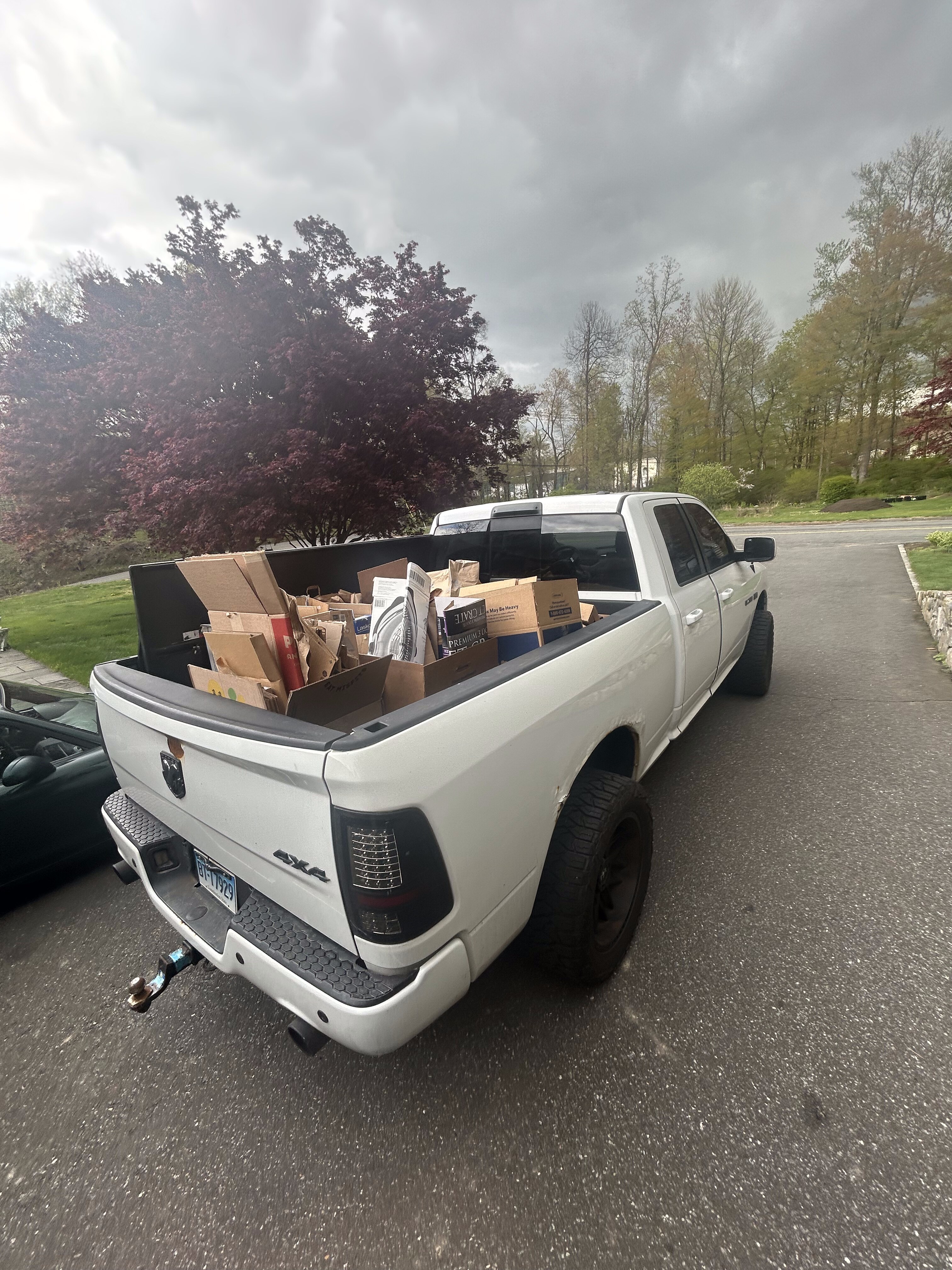 Load & Go truck bed fully loaded with cardboard and junk for haul away in CT