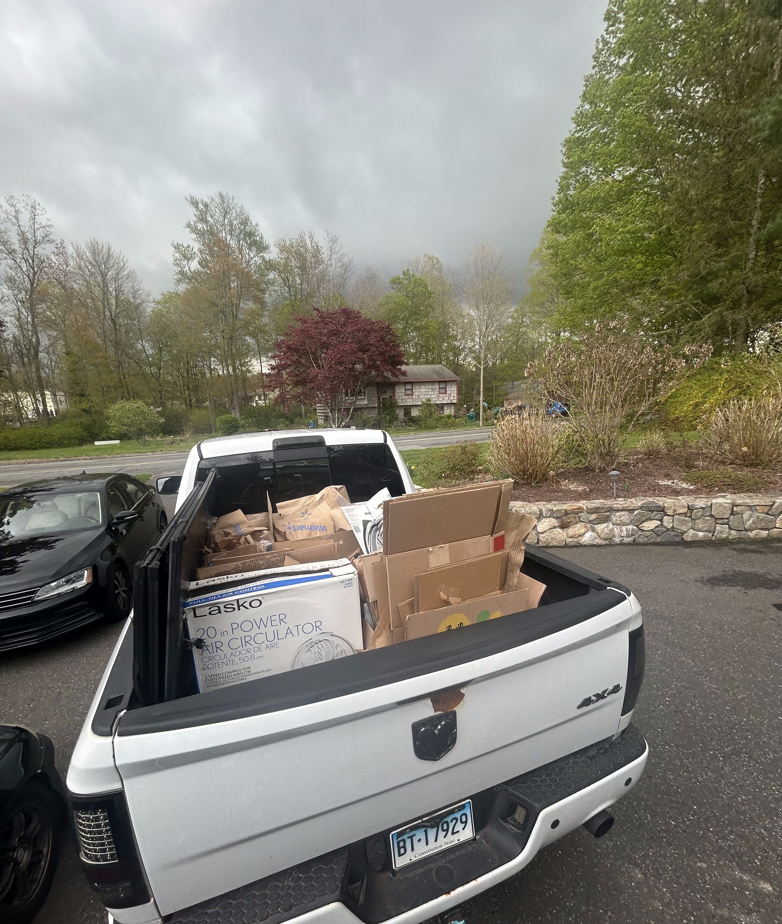 Load & Go truck bed loaded with boxes and appliances after junk removal job in CT